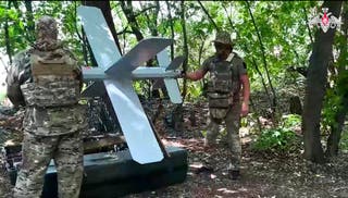 Russian soldiers prepare a Lancet drone for action in an undisclosed location in Ukraine